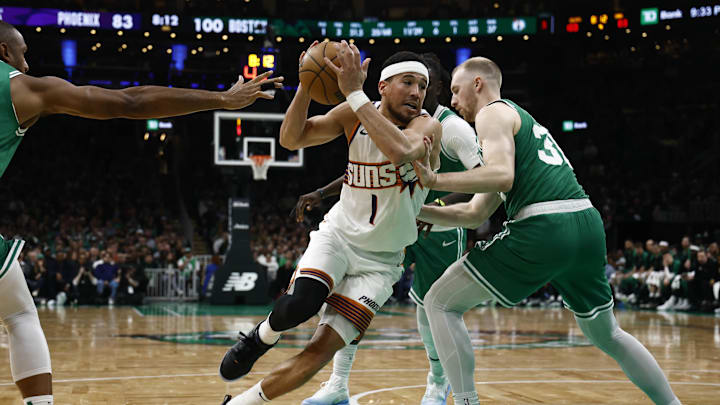 Apr 4, 2025; Boston, Massachusetts, USA; Phoenix Suns guard Devin Booker (1) drives between Boston Celtics forward Sam Hauser (30) and center Al Horford (42) during the second half at TD Garden. Mandatory Credit: Winslow Townson-Imagn Images