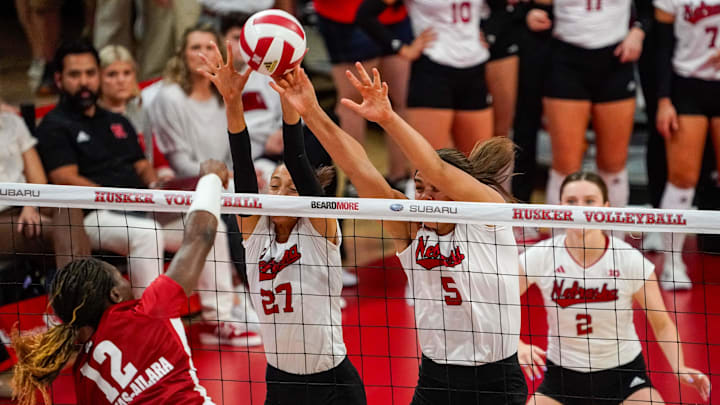 Nebraska Cornhuskers outside hitter Harper Murray (27) and middle blocker Bekka Allick (5) block Wisconsin Badgers outside hitter Temi Thomas-Ailara (12) in 2023.