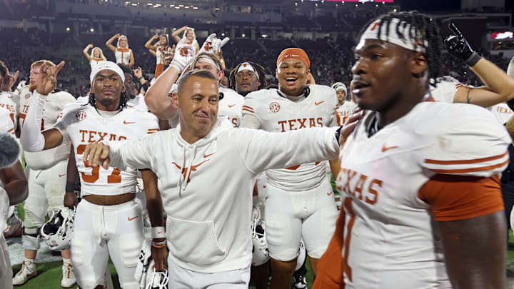 Oct 25, 2025; Starkville, Mississippi, USA; Texas Longhorns head coach Steve Sarkisian reacts with defensive linemen Colin Simmons (1) after beating the Mississippi State Bulldogs in overtime at Davis Wade Stadium at Scott Field. Mandatory Credit: Petre Thomas-Imagn Images