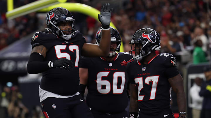 Dec 14, 2025; Houston, Texas, USA; Houston Texans running back Woody Marks (27), offensive tackle Blake Fisher (57) and center Jake Andrews (60) celebrate a touchdown during the first quarter against the Arizona Cardinals at NRG Stadium. Mandatory Credit: Thomas Shea-Imagn Images