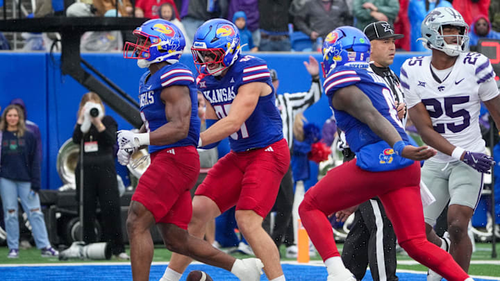 Oct 25, 2025; Lawrence, Kansas, USA; Kansas Jayhawks running back Daniel Hishaw Jr. (9) celebrates with team mates against the Kansas State Wildcats after scoring during the first half of the game at David Booth Kansas Memorial Stadium. Mandatory Credit: Denny Medley-Imagn Images Oct 25, 2025; Lawrence, Kansas, USA; Kansas Jayhawks running back Daniel Hishaw Jr. (9) celebrates with team mates against the Kansas State Wildcats after scoring during the first half of the game at David Booth Kansas Memorial Stadium. Mandatory Credit: Denny Medley-Imagn Images