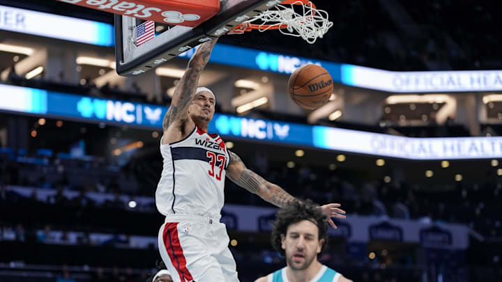 Feb 3, 2025; Charlotte, North Carolina, USA;  Washington Wizards forward Kyle Kuzma (33) with a dunk against the Charlotte Hornets during the second half at Spectrum Center. Mandatory Credit: Jim Dedmon-Imagn Images