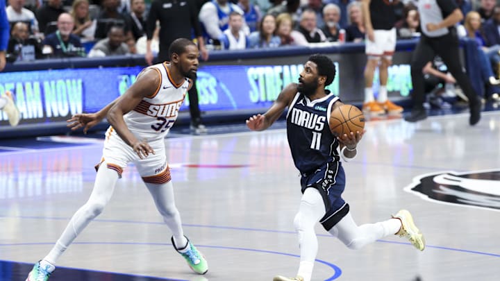 Nov 8, 2024; Dallas, Texas, USA;  Dallas Mavericks guard Kyrie Irving (11) drives to the basket as Phoenix Suns forward Kevin Durant (35) defends during the fourth quarter at American Airlines Center. Mandatory Credit: Kevin Jairaj-Imagn Images
