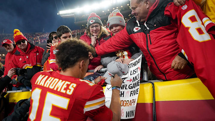 Nov 29, 2024; Kansas City, Missouri, USA; Kansas City Chiefs quarterback Patrick Mahomes (15) signs autographs for fans after the win over the Las Vegas Raiders at GEHA Field at Arrowhead Stadium. Mandatory Credit: Denny Medley-Imagn Images