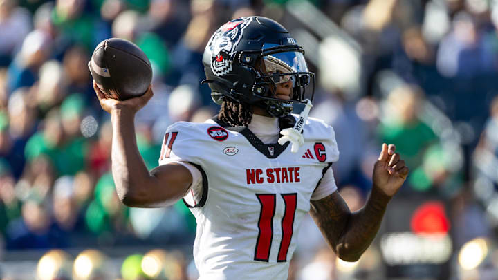 Oct 11, 2025; South Bend, Indiana, USA; NC State Wolfpack quarterback CJ Bailey (11) throws a pass against the Notre Dame Fighting Irish during the first half at Notre Dame Stadium. Mandatory Credit: Michael Caterina-Imagn Images