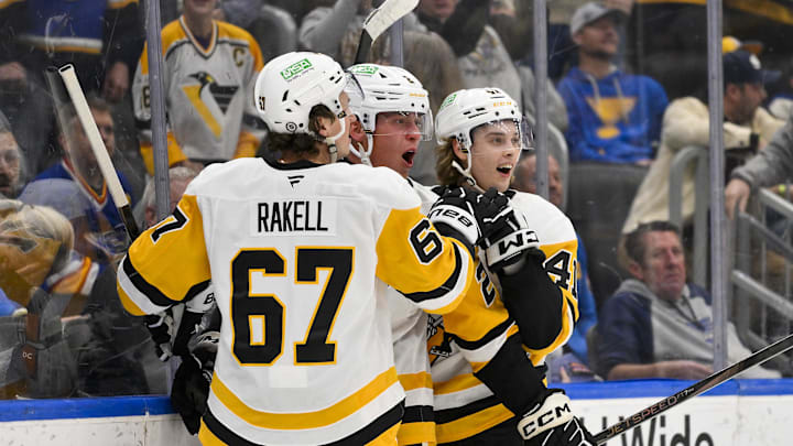 Apr 3, 2025; St. Louis, Missouri, USA;  Pittsburgh Penguins right wing Rutger McGroarty (2) is congratulated by right wing Rickard Rakell (67) and right wing Ville Koivunen (41) after scoring his first NHL goal to tie the game against the St. Louis Blues during the third period at Enterprise Center. Mandatory Credit: Jeff Curry-Imagn Images