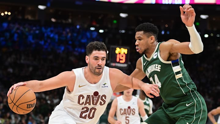 Jan 24, 2024; Milwaukee, Wisconsin, USA;  Cleveland Cavaliers forward Georges Niang (20) drives for the basket against Milwaukee Bucks forward Giannis Antetokounmpo (34) in the third quarter at Fiserv Forum. Mandatory Credit: Benny Sieu-Imagn Images