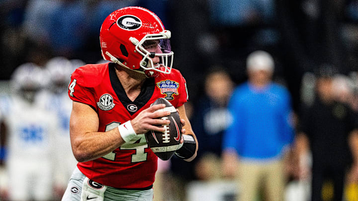 Georgia quarterback Gunner Stockton (14) rolls out of the pocket during the Sugar Bowl and College Football Playoff quarterfinals at Caesars Superdome in New Orleans, La., on Thursday, Jan. 1, 2026. Ole Miss defeated Georgia 39-34.