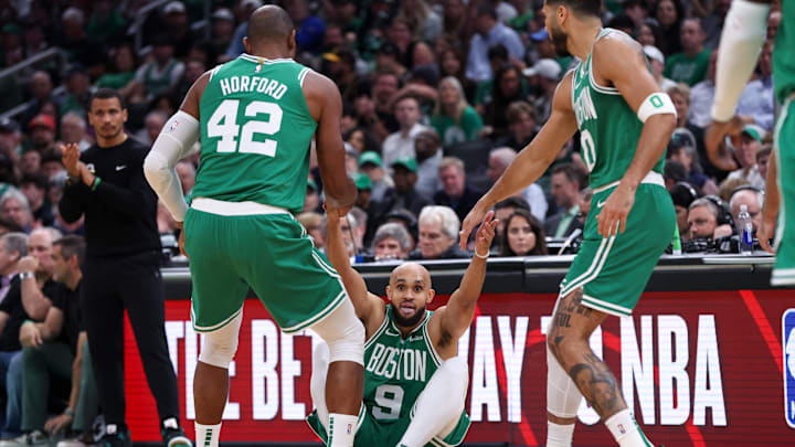 Nov 6, 2024; Boston, Massachusetts, USA; Boston Celtics forward Jayson Tatum (0) and center Al Horford (42) help up Boston Celtics guard Derrick White (9) during the first half against the Golden State Warriors at TD Garden. Mandatory Credit: Paul Rutherford-Imagn Images