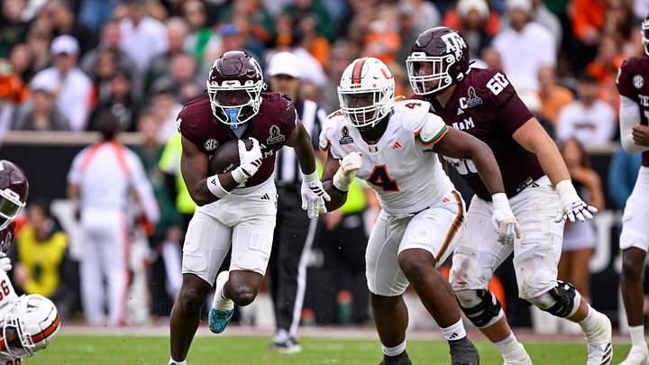 Dec 20, 2025; College Station, TX, USA; Texas A&M Aggies running back Rueben Owens II (4) runs with the ball past Miami Hurricanes defensive lineman Rueben Bain Jr. (4) during the game between the Aggies and the Hurricanes at Kyle Field. Mandatory Credit: Jerome Miron-Imagn Images Dec 20, 2025; College Station, TX, USA; Texas A&M Aggies running back Rueben Owens II (4) runs with the ball past Miami Hurricanes defensive lineman Rueben Bain Jr. (4) during the game between the Aggies and the Hurricanes at Kyle Field. Mandatory Credit: Jerome Miron-Imagn Images