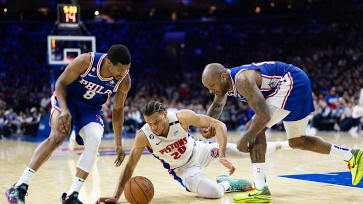 Jan 10, 2023; Philadelphia, Pennsylvania, USA; Detroit Pistons forward Kevin Knox II (20) and Philadelphia 76ers forward P.J. Tucker (17) and guard De'Anthony Melton (8) battle for a loose ball during the third quarter at Wells Fargo Center. Mandatory Credit: Bill Streicher-Imagn Images