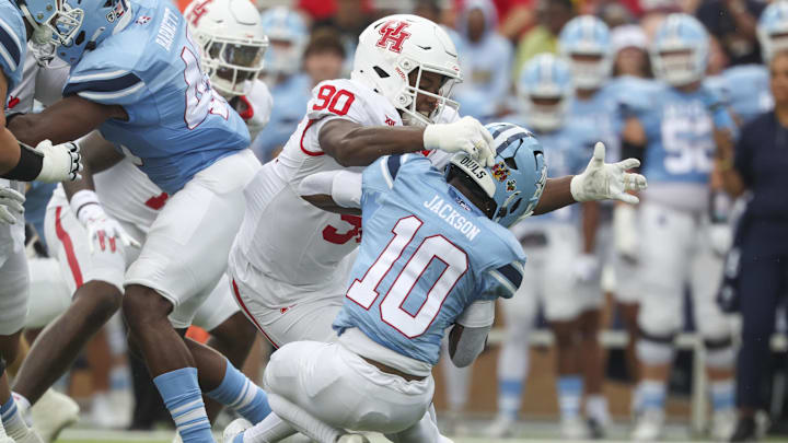 Houston Cougars defensive lineman Eddie Walls III (90) tackles Rice Owls running back Quinton Jackson (10) during the first quarter at Rice Stadium.
