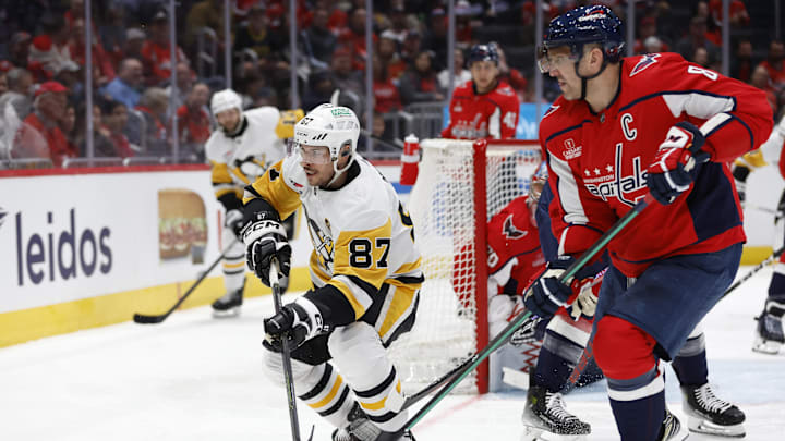 Apr 4, 2024; Washington, District of Columbia, USA; Pittsburgh Penguins center Sidney Crosby (87) and Washington Capitals left wing Alex Ovechkin (8) chase the puck in the second period at Capital One Arena. Mandatory Credit: Geoff Burke-Imagn Images