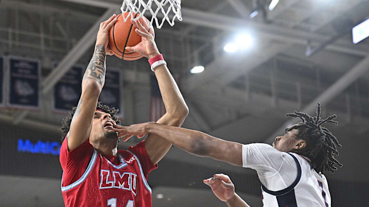 Feb 6, 2025; Spokane, Washington, USA; Loyola Marymount Lions forward Jevon Porter (14) rebounds against Gonzaga Bulldogs guard Michael Ajayi (1) in the first half at McCarthey Athletic Center. Mandatory Credit: James Snook-Imagn Images
