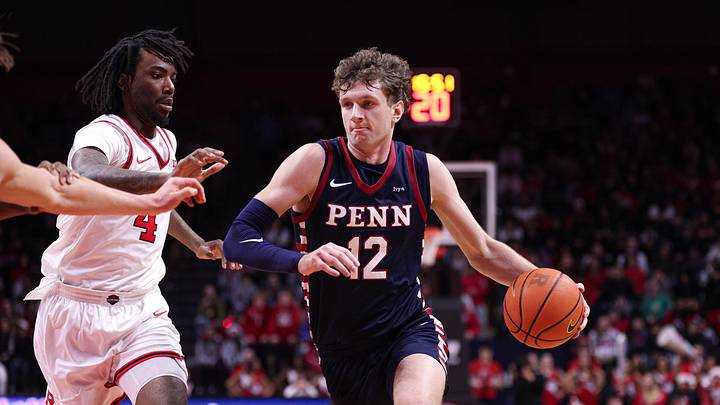 Dec 20, 2025; Piscataway, New Jersey, USA; Penn Quakers forward TJ Power (12) goes to the basket against Rutgers Scarlet Knights forward Bryce Dortch (4) during the first half at Jersey Mike's Arena. Mandatory Credit: Vincent Carchietta-Imagn Images