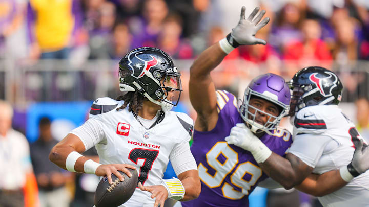 Sep 22, 2024; Minneapolis, Minnesota, USA; Houston Texans quarterback C.J. Stroud (7) drops back to pass against the Minnesota Vikings defensive tackle Jerry Tillery (99) in the first quarter at U.S. Bank Stadium. Mandatory Credit: Brad Rempel-Imagn Images