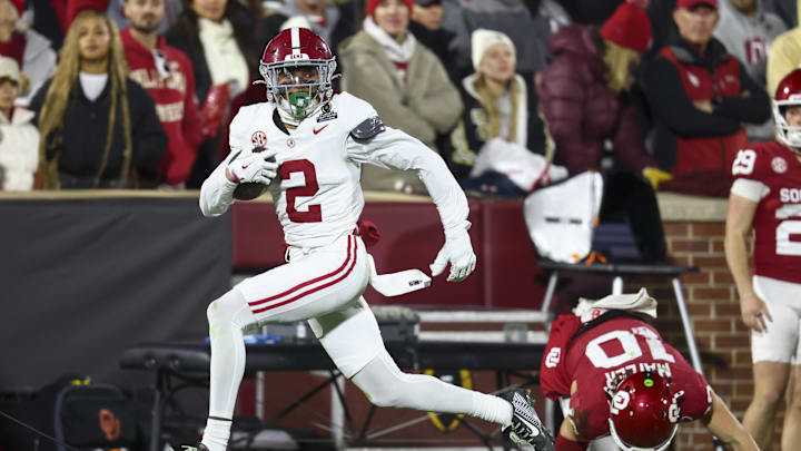 Dec 19, 2025; Norman, OK, USA; Alabama Crimson Tide defensive back Zabien Brown (2) eludes a tackle by Oklahoma Sooners quarterback John Mateer (10) in the first half at Gaylord Family OK Memorial Stadium. Mandatory Credit: Mark J. Rebilas-Imagn Images