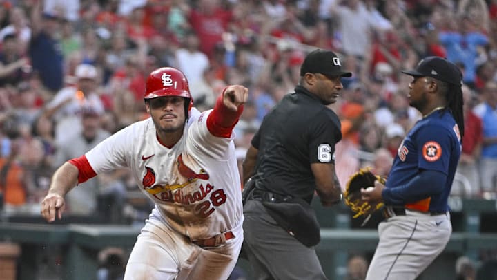 Jun 27, 2023; St. Louis, Missouri, USA; St. Louis Cardinals third baseman Nolan Arenado (28) points to his dugout to challenge the out call at home after sliding past the tag of Houston Astros starting pitcher Framber Valdez (59) during the fifth inning at Busch Stadium. Arenado was called out on the play but the call was overturned after a successful challenge by the Cardinals. Mandatory Credit: Jeff Curry-Imagn Images Jun 27, 2023; St. Louis, Missouri, USA; St. Louis Cardinals third baseman Nolan Arenado (28) points to his dugout to challenge the out call at home after sliding past the tag of Houston Astros starting pitcher Framber Valdez (59) during the fifth inning at Busch Stadium. Arenado was called out on the play but the call was overturned after a successful challenge by the Cardinals. Mandatory Credit: Jeff Curry-Imagn Images