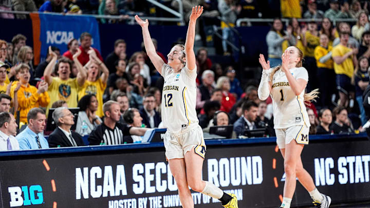 Michigan guard Syla Swords (12) and guard Olivia Olson (1) wave at fans as they exit the floor for substitution during the second half of NCAA Tournament Second Round against N.C. State at Crisler Center in Ann Arbor on Sunday, March 22, 2026. Michigan guard Syla Swords (12) and guard Olivia Olson (1) wave at fans as they exit the floor for substitution during the second half of NCAA Tournament Second Round against N.C. State at Crisler Center in Ann Arbor on Sunday, March 22, 2026.