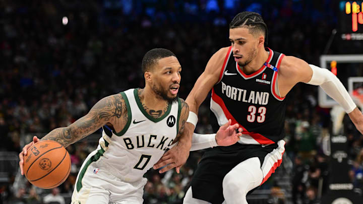 Jan 4, 2025; Milwaukee, Wisconsin, USA;  Milwaukee Bucks guard Damian Lillard (0) drives for the basket against Portland Trail Blazers forward Toumani Camara (33) in the third quarter at Fiserv Forum. Mandatory Credit: Benny Sieu-Imagn Images