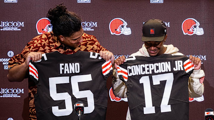Apr 24, 2026; Berea, OH, USA; Cleveland Browns first round draft picks Spencer Fano, left, and KC Concepcion hold their new jerseys during an introductory press conference at CrossCountry Mortgage Campus. Mandatory Credit: Ken Blaze-Imagn Images