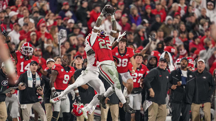 Nov 11, 2023; Athens, Georgia, USA; Georgia Bulldogs defensive back Javon Bullard (22) intercepts a pass over top of Mississippi Rebels wide receiver Dayton Wade (19) during the first half at Sanford Stadium. Mandatory Credit: Dale Zanine-Imagn Images