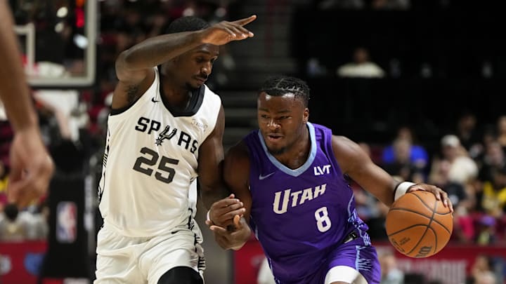 Jul 14, 2025; Las Vegas, NV, USA;  Utah Jazz guard Isaiah Collier (8) drives the ball against San Antonio Spurs forward David Jones-Garcia (25) during the first half of a NBA basketball game at the Thomas & Mack Center. Mandatory Credit: Lucas Peltier-Imagn Images