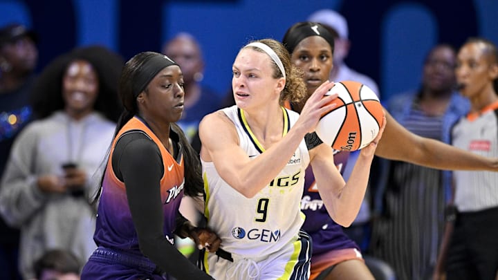 Sep 11, 2025; Arlington, Texas, USA; Dallas Wings guard Grace Berger (9) moves the ball past Phoenix Mercury guard Kahleah Copper (2) during the second half at College Park Center. Mandatory Credit: Jerome Miron-Imagn Images