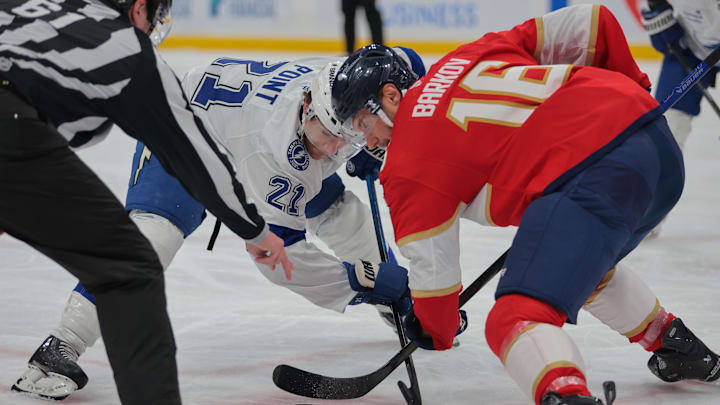 Mar 3, 2025; Sunrise, Florida, USA; Tampa Bay Lightning center Brayden Point (21) and Florida Panthers center Aleksander Barkov (16) face-off during the first period at Amerant Bank Arena. Mandatory Credit: Sam Navarro-Imagn Images