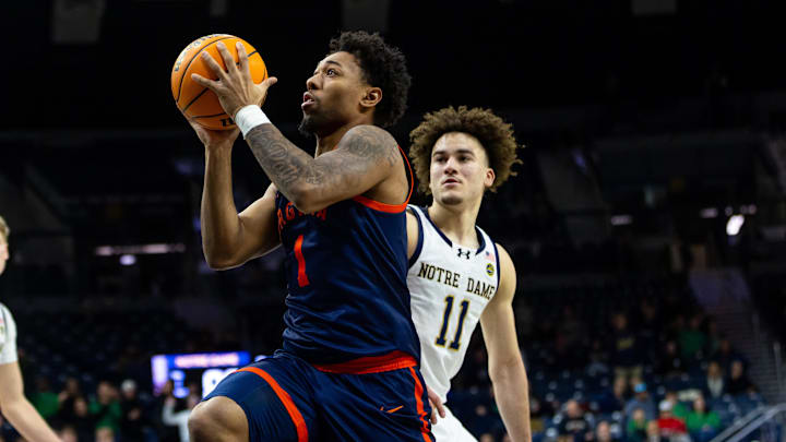 Jan 27, 2026; South Bend, Indiana, USA; Virginia Cavaliers guard Malik Thomas (1) drives past Notre Dame Fighting Irish guard Braeden Shrewsberry (11) during the first overtime at Purcell Pavilion at the Joyce Center. Mandatory Credit: Michael Caterina-Imagn Images