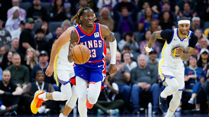 Feb 21, 2025; Sacramento, California, USA; Sacramento Kings guard Keon Ellis (23) steals the ball from Golden State Warriors guard Stephen Curry (30) during the first quarter at Golden 1 Center. Mandatory Credit: Sergio Estrada-Imagn Images