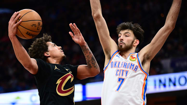 Jan 19, 2026; Cleveland, Ohio, USA; Cleveland Cavaliers guard Craig Porter Jr. (9) drives to the basket against Oklahoma City Thunder center Chet Holmgren (7) during the second half at Rocket Arena. Mandatory Credit: Ken Blaze-Imagn Images