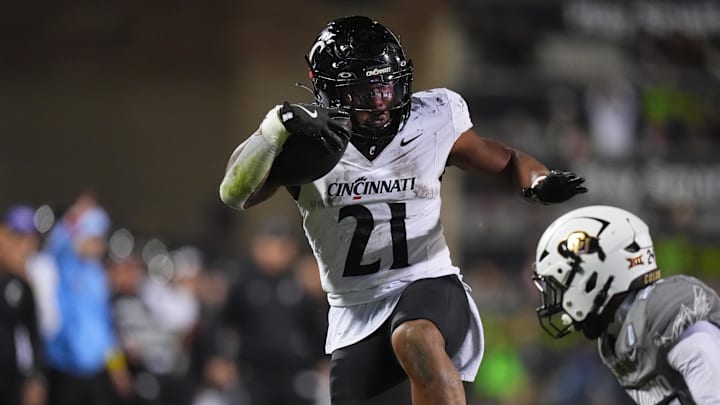 Oct 26, 2024; Boulder, Colorado, USA; Cincinnati Bearcats running back Corey Kiner (21) carries the ball in the fourth quarter against the Colorado Buffaloes at Folsom Field. Mandatory Credit: Ron Chenoy-Imagn Images