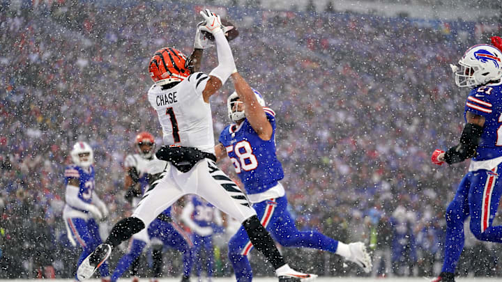 Cincinnati Bengals wide receiver Ja'Marr Chase (1) leaps fo a catch in the zone as Buffalo Bills linebacker Matt Milano (58) defends in the second quarter during an NFL divisional playoff football game between the Cincinnati Bengals and the Buffalo Bills, Sunday, Jan. 22, 2023, at Highmark Stadium in Orchard Park, N.Y. The catch was ruled incomplete upon further review.