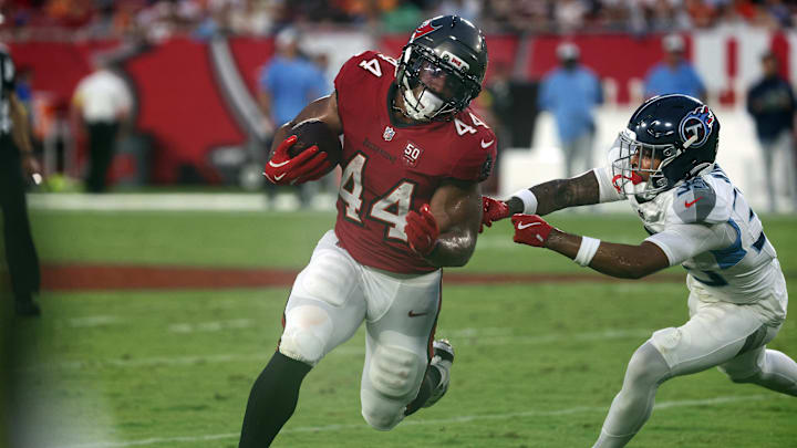 Aug 9, 2025; Tampa, Florida, USA;  Tampa Bay Buccaneers running back Sean Tucker (44) runs past Tennessee Titans cornerback Jalen Kimber (35) during the first half at Raymond James Stadium. Mandatory Credit: Kim Klement Neitzel-Imagn Images
