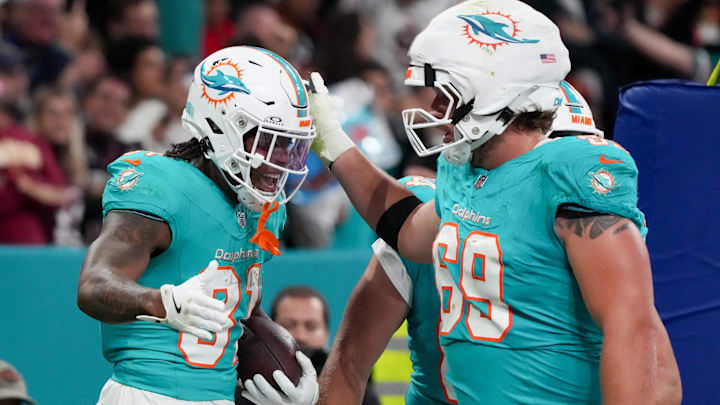 Miami Dolphins running back Ollie Gordon II (31) celebrates after scoring a touchdown against the Washington Commanders with teammates in the fourth quarter during the 2025 NFL Madrid Game at Santiago Bernabeu Stadium.