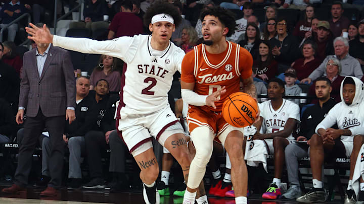 Mar 3, 2025; Memphis, Tennessee, USA; Texas Longhorns guard Jordan Pope (0) handles the ball as Mississippi State Bulldogs guard Riley Kugel (2) defends during the first half at FedExForum. Mandatory Credit: Petre Thomas-Imagn Images