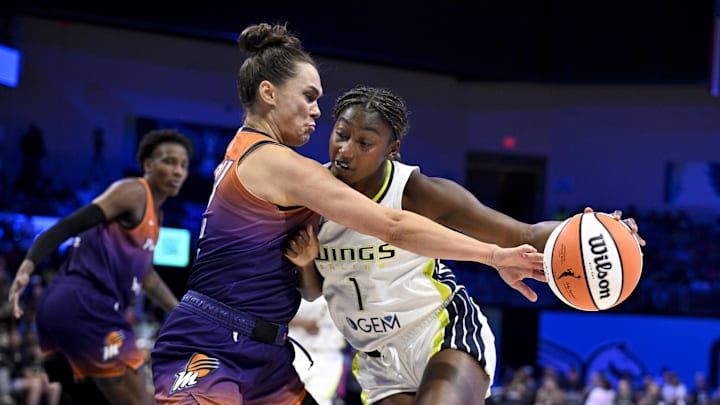 Sep 11, 2025; Arlington, Texas, USA; Phoenix Mercury forward Kathryn Westbeld (24) and Dallas Wings forward Diamond Miller (1) battle for control of the ball during the first half at College Park Center. Mandatory Credit: Jerome Miron-Imagn Images