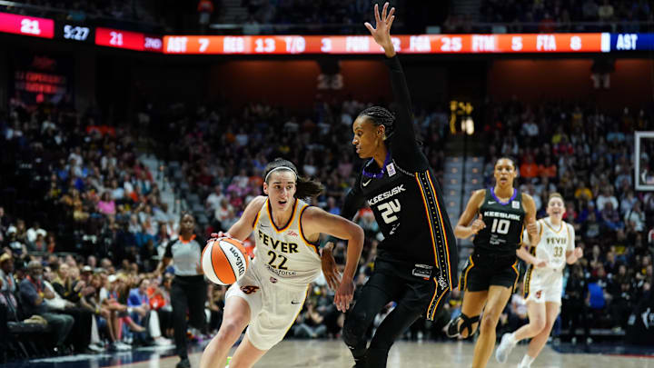 May 14, 2024; Uncasville, Connecticut, USA; Indiana Fever guard Caitlin Clark (22) drives the ball against Connecticut Sun forward DeWanna Bonner (24) in the first quarter at Mohegan Sun Arena. Mandatory Credit: David Butler II-Imagn Images