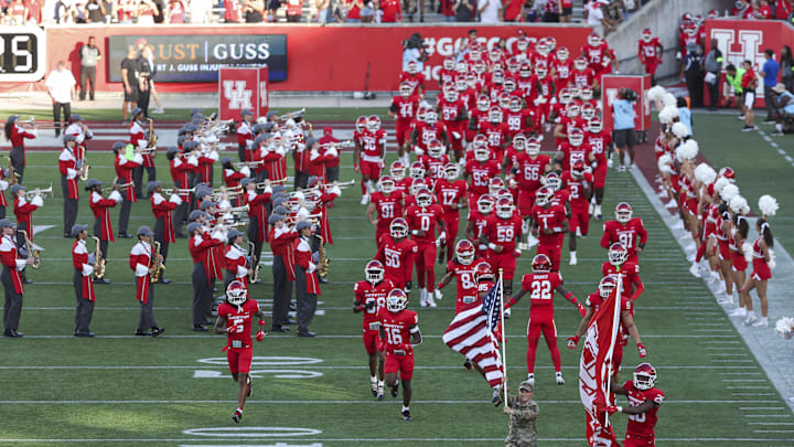 Houston Cougars players run onto the field before the game against the Iowa State Cyclones