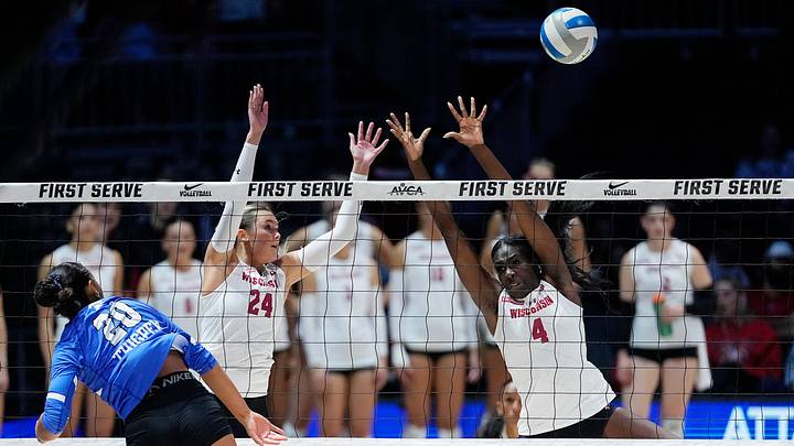 Wisconsin Badgers setter Charlie Fuerbringer (24) and Wisconsin Badgers middle blocker Jaela Auguste (4) miss to block the attack from Kentucky Wildcats outside hitter Asia Thigpen (20) during the second set of their match at the AVCA First Serve event at Fiserv Forum in Milwaukee, Wisconsin on Aug. 21, 2026.
