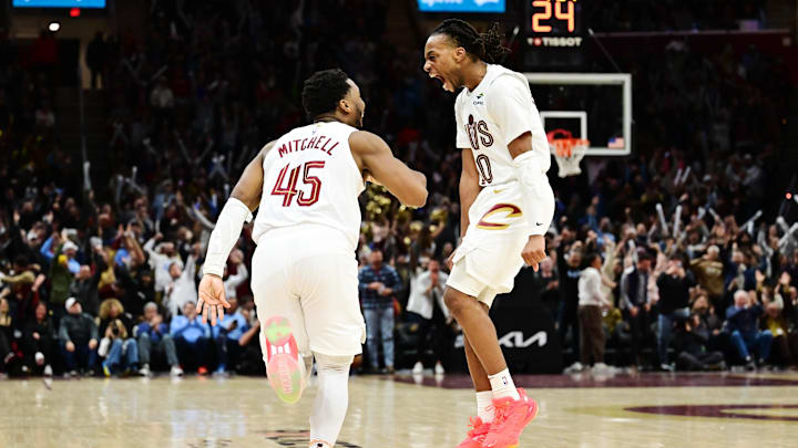 Jan 8, 2025; Cleveland, Ohio, USA; Cleveland Cavaliers guard Donovan Mitchell (45) and guard Darius Garland (10) celebrate after Mitchell made a three point basket during the second half against the Oklahoma City Thunder at Rocket Mortgage FieldHouse. Mandatory Credit: Ken Blaze-Imagn Images