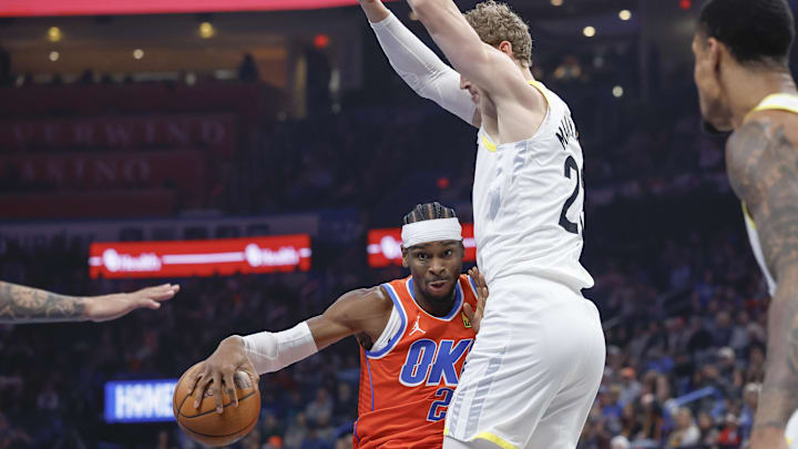 Dec 3, 2024; Oklahoma City, Oklahoma, USA; Oklahoma City Thunder guard Shai Gilgeous-Alexander (2) moves the ball against Utah Jazz forward Lauri Markkanen (23) during the first quarter of an NBA Cup game at Paycom Center. Mandatory Credit: Alonzo Adams-Imagn Images