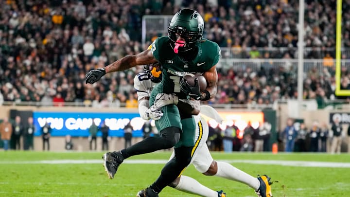 Oct 25, 2025; East Lansing, Michigan, USA; Michigan State Spartans wide receiver Chrishon McCray (13) is tackled after the catch by Michigan Wolverines defensive back Jyaire Hill (20) during the first half at Spartan Stadium. Mandatory Credit: Brendan Mullin-Imagn Images
