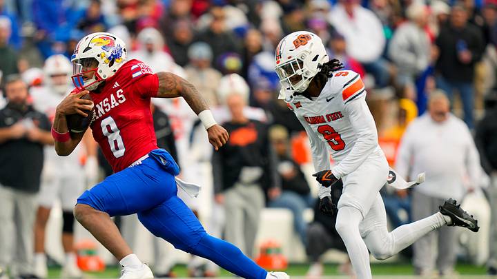 Nov 1, 2025; Lawrence, Kansas, USA; Kansas Jayhawks quarterback Isaiah Marshall (8) runs the ball against Oklahoma State Cowboys cornerback Ladainian Fields (9) during the second half at David Booth Kansas Memorial Stadium. Mandatory Credit: Jay Biggerstaff-Imagn Images Nov 1, 2025; Lawrence, Kansas, USA; Kansas Jayhawks quarterback Isaiah Marshall (8) runs the ball against Oklahoma State Cowboys cornerback Ladainian Fields (9) during the second half at David Booth Kansas Memorial Stadium. Mandatory Credit: Jay Biggerstaff-Imagn Images