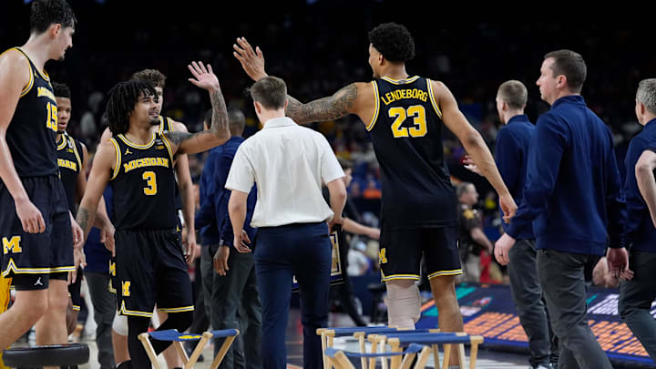 Michigan guard Elliot Cadeau (3) high-fives teammate Yaxel Lendeborg (23) in the second half of their Final Four game against Arizona at Lucas Oil Stadium in Indianapolis on Saturday, April 4, 2026. Michigan guard Elliot Cadeau (3) high-fives teammate Yaxel Lendeborg (23) in the second half of their Final Four game against Arizona at Lucas Oil Stadium in Indianapolis on Saturday, April 4, 2026.