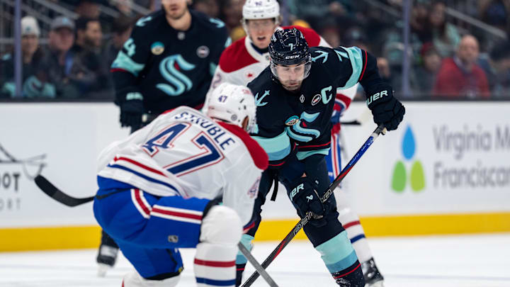 Mar 12, 2025; Seattle, Washington, USA;  Seattle Kraken forward Jordan Eberle (7) and Montreal Canadiens defenseman Jayden Struble (47) battle for the puck during the first period at Climate Pledge Arena. Mandatory Credit: Stephen Brashear-Imagn Images
