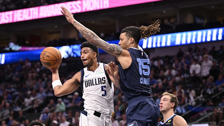 Oct 7, 2024; Dallas, Texas, USA; Dallas Mavericks guard Quentin Grimes (5) passes the ball in front of Memphis Grizzlies forward Brandon Clarke (15) during the first quarter at the American Airlines Center. Mandatory Credit: Jerome Miron-Imagn Images