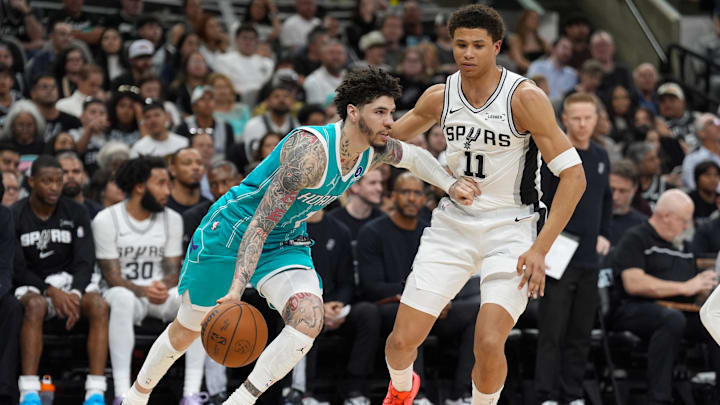 Charlotte Hornets guard LaMelo Ball (1) dribbles against San Antonio Spurs forward Carter Bryant 
