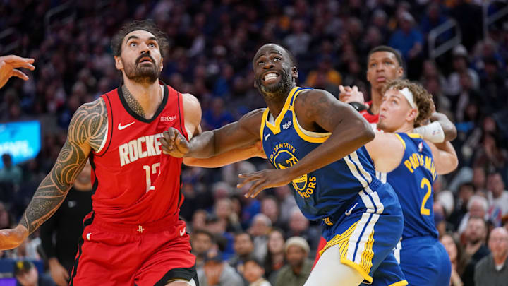 Golden State Warriors forward Draymond Green battles for position with Houston Rockets center Steven Adams.